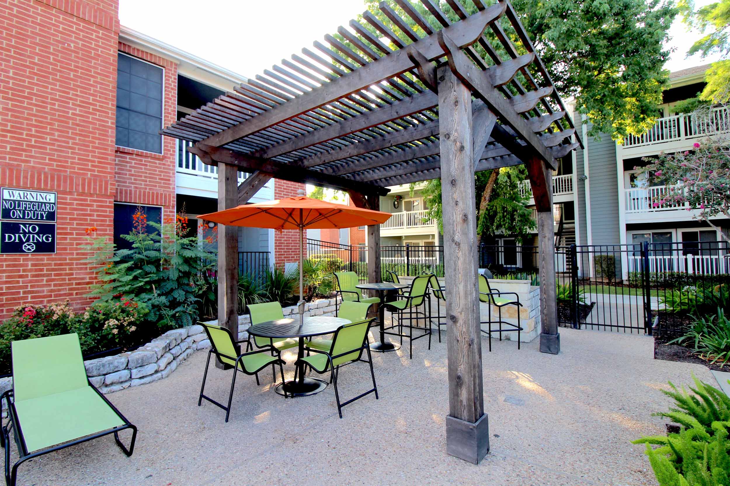 Communal grilling area on patio with tables and chairs