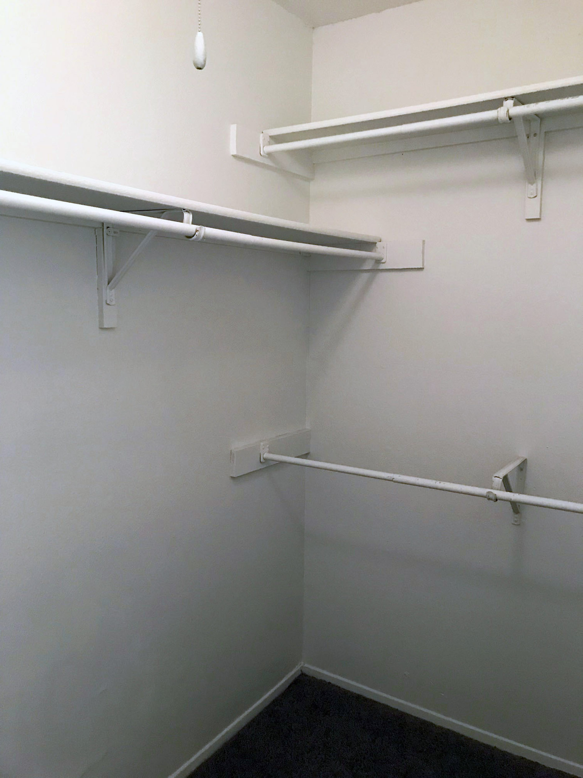 Empty closet with rods and shelving