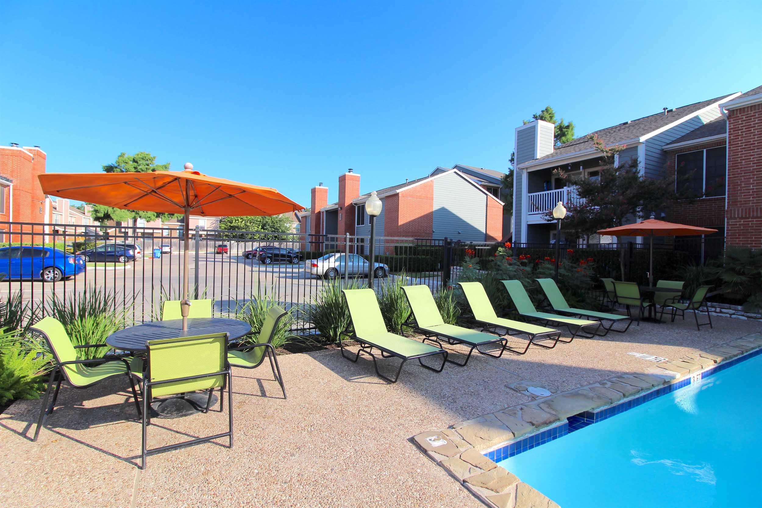 View of apartments with swimming pool and poolside loungers