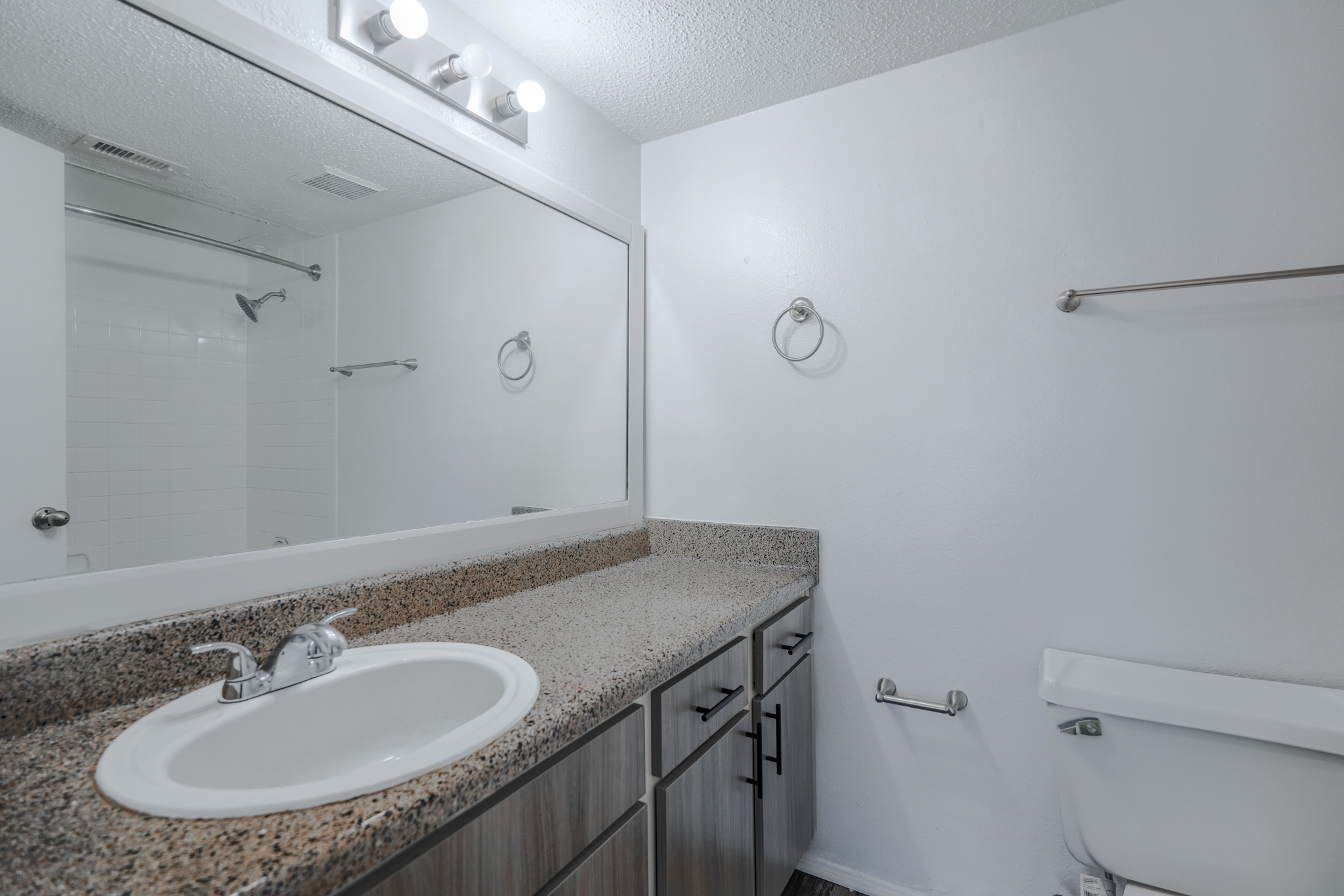 a bathroom with a marble countertop and a mirror