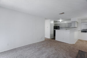 a room with a kitchen and a counter