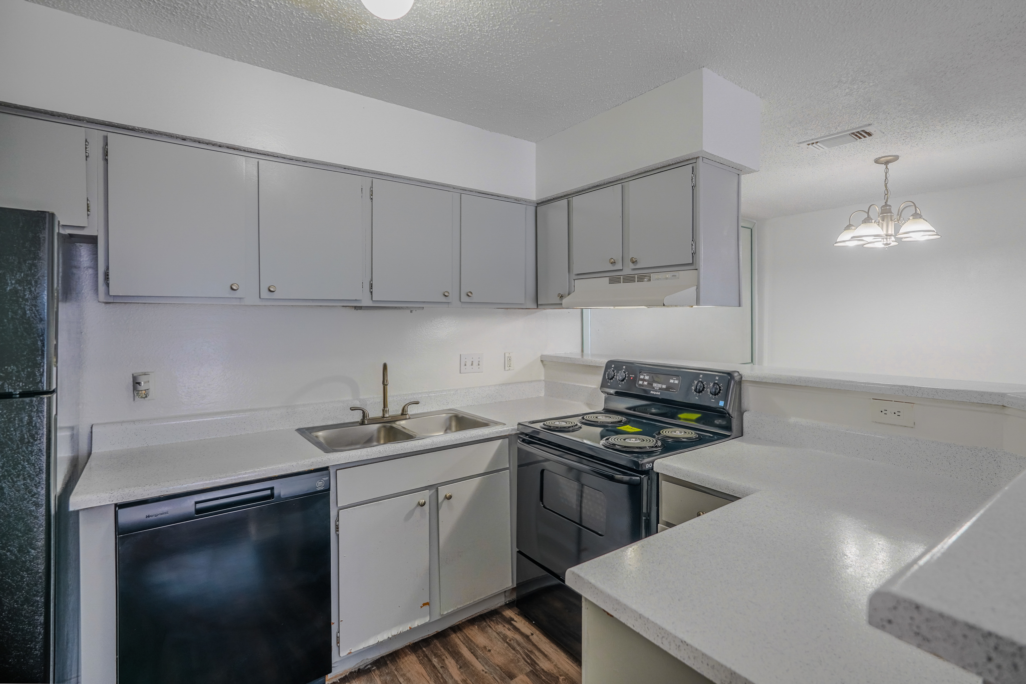 a kitchen with white cabinets and a sink