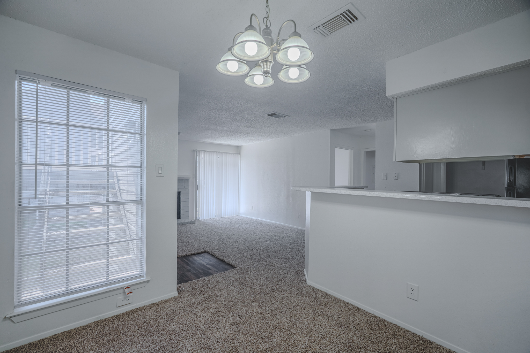 a room with a kitchen and dining area