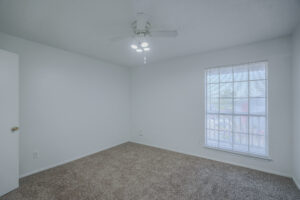 a room with a ceiling fan and a window