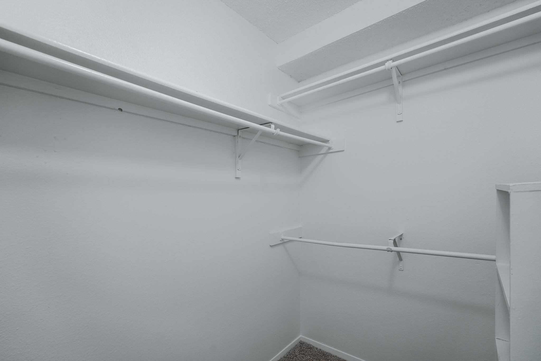 a white empty closet with shelves