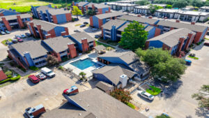 a group of houses with cars parked in front of them