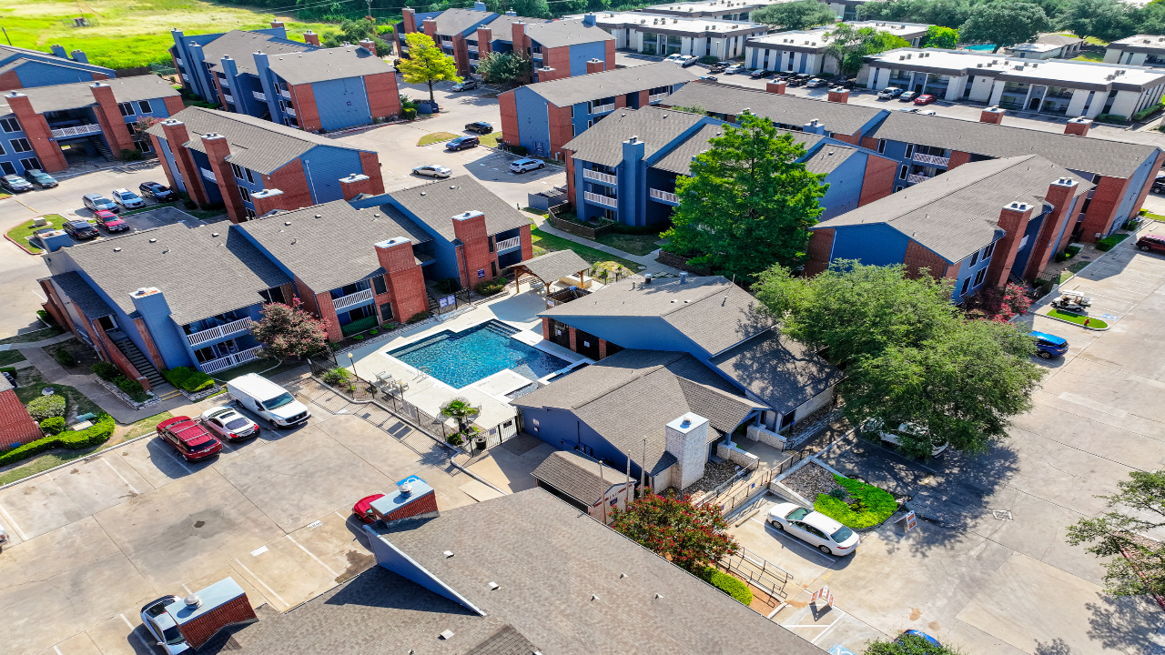 a group of houses with cars parked in front of them