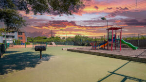 a playground with a playground and a barbeque