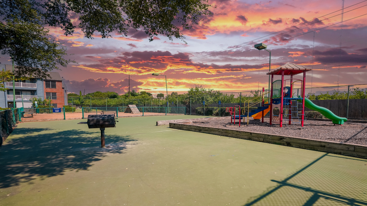 a playground with a playground and a barbeque