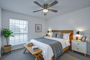 a bedroom with a bed and a ceiling fan