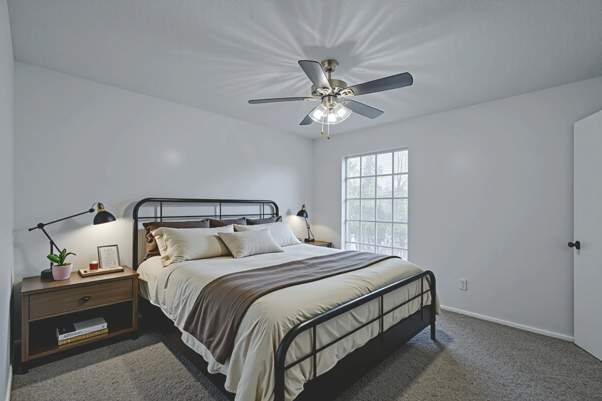 a bedroom with a ceiling fan and a bed